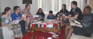 Mr. Veenstra and Mr. Bolt meet with their thesis group over pizza and great books in Mr. Bolt's living room.