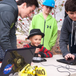 Club members help Thor with the robot controls during an open house Dec. 12.