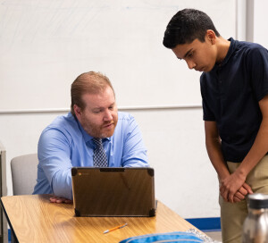 Mr. Veenstra works with a student.